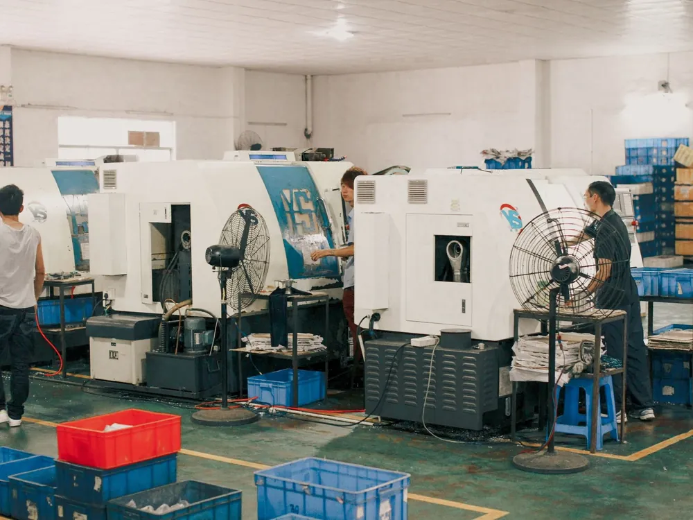 Workers operating machinery on a factory floor