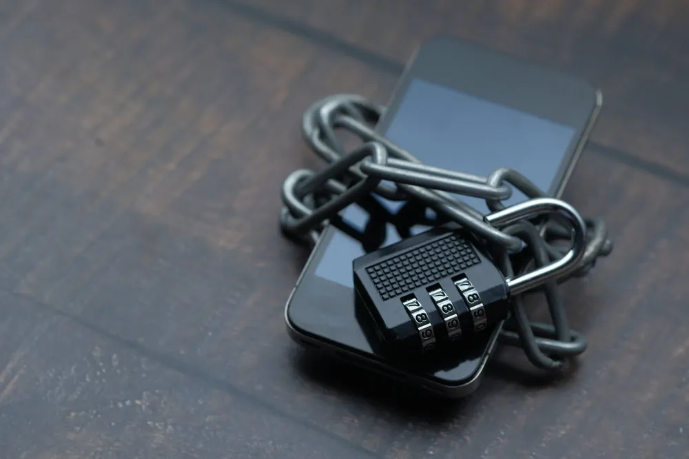 Smartphone wrapped in a chain with a padlock